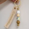Porte-clés personnalisé artisanal avec perles et breloques. Modèle aléatoire unique, fabriqué avec soin en Franche-Comté.